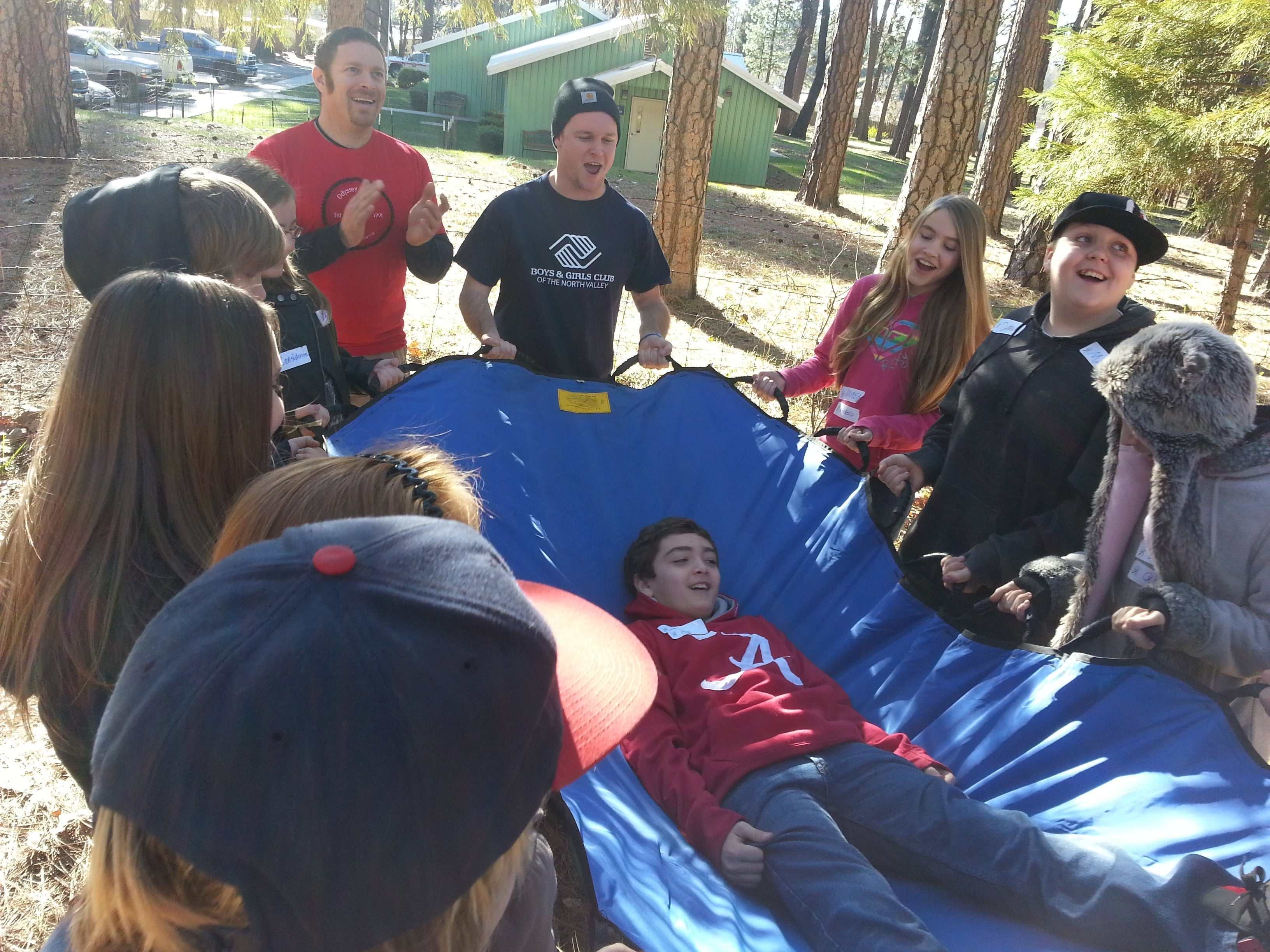Boy named Nobody wearing a nametag during a ropes course encouraging support and trust among students