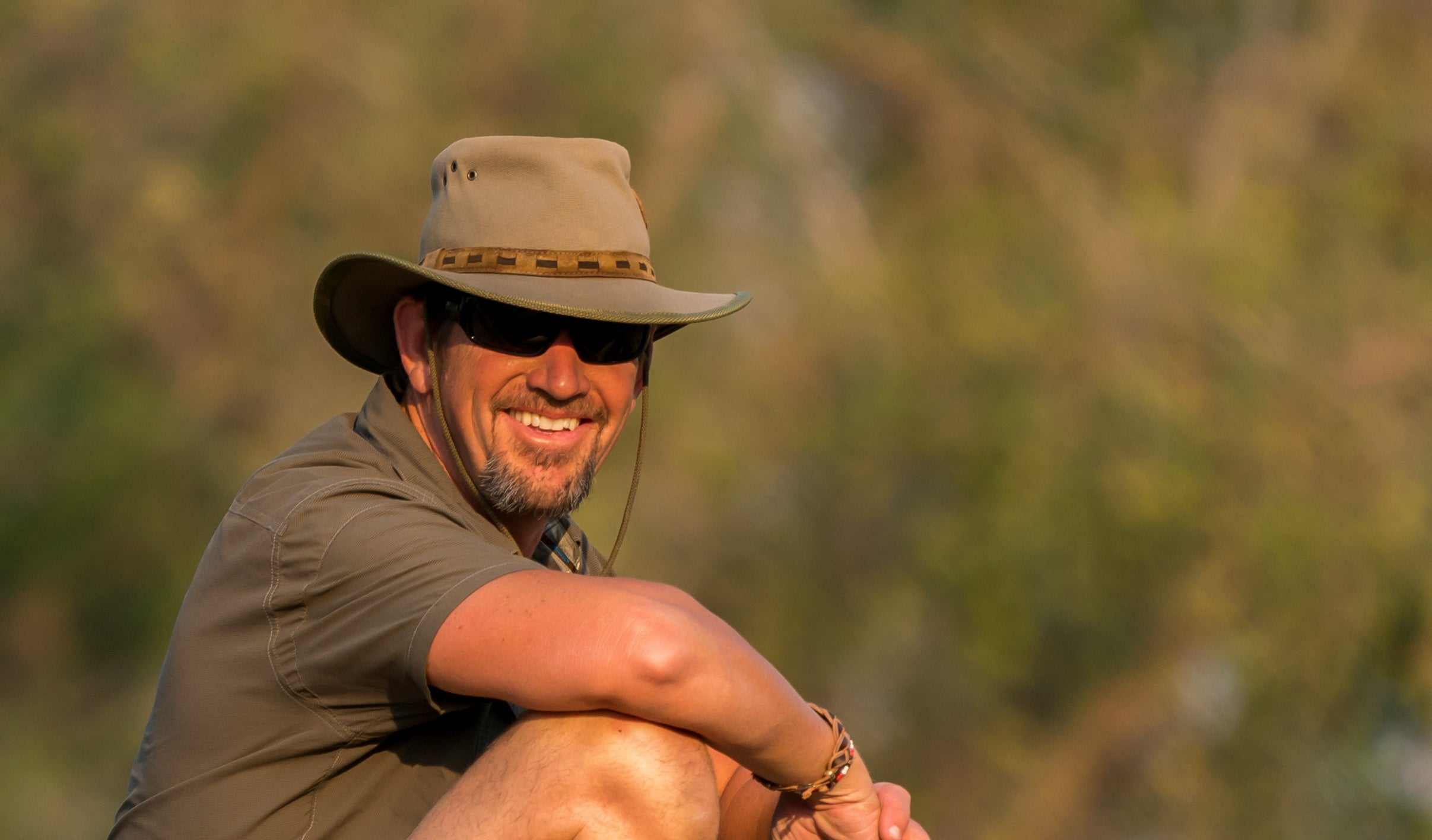 Bill John photographing a tiger in the wild, symbolizing wildlife photography and leadership connection