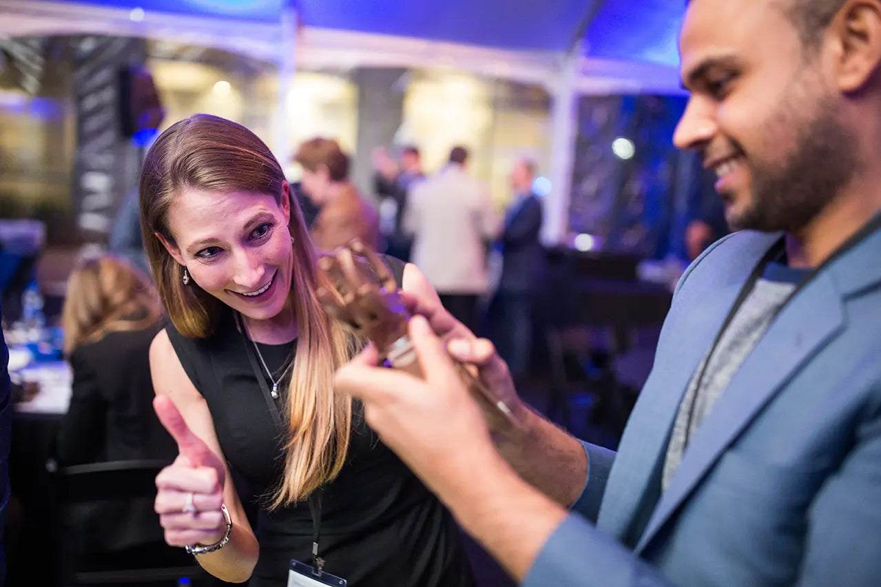 Corporate professionals engaged in philanthropic team building by assembling prosthetic hands for recipients.