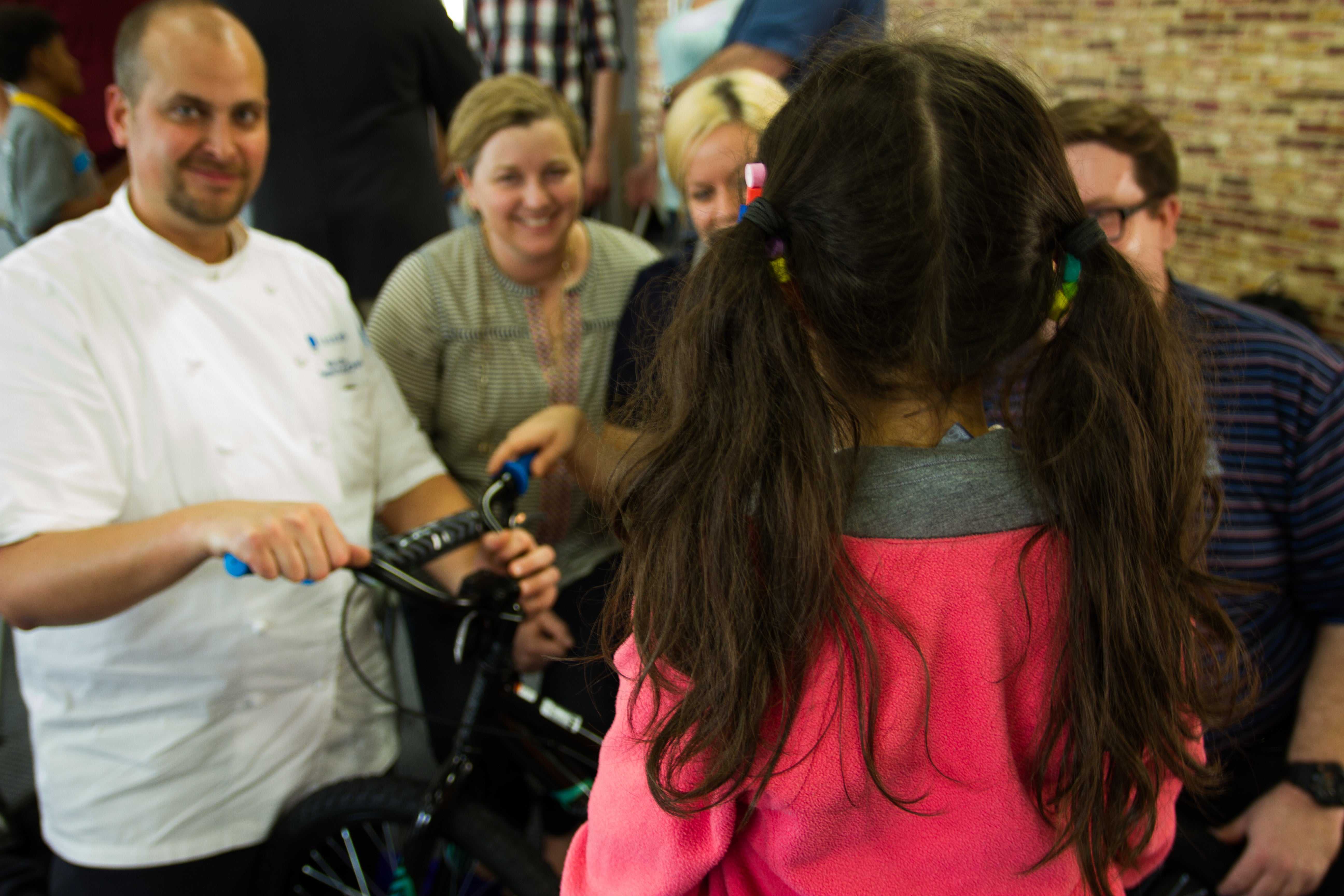 Team building workshop with Life Cycles program participants assembling bikes for children to foster emotional learning and collaboration