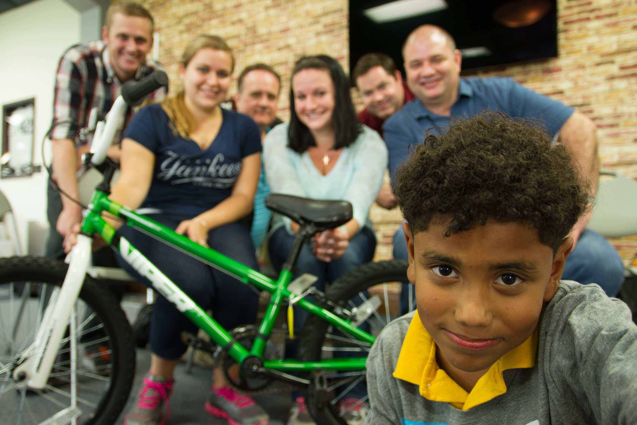 Team-building workshop with participants collaborating on building bicycles for charity