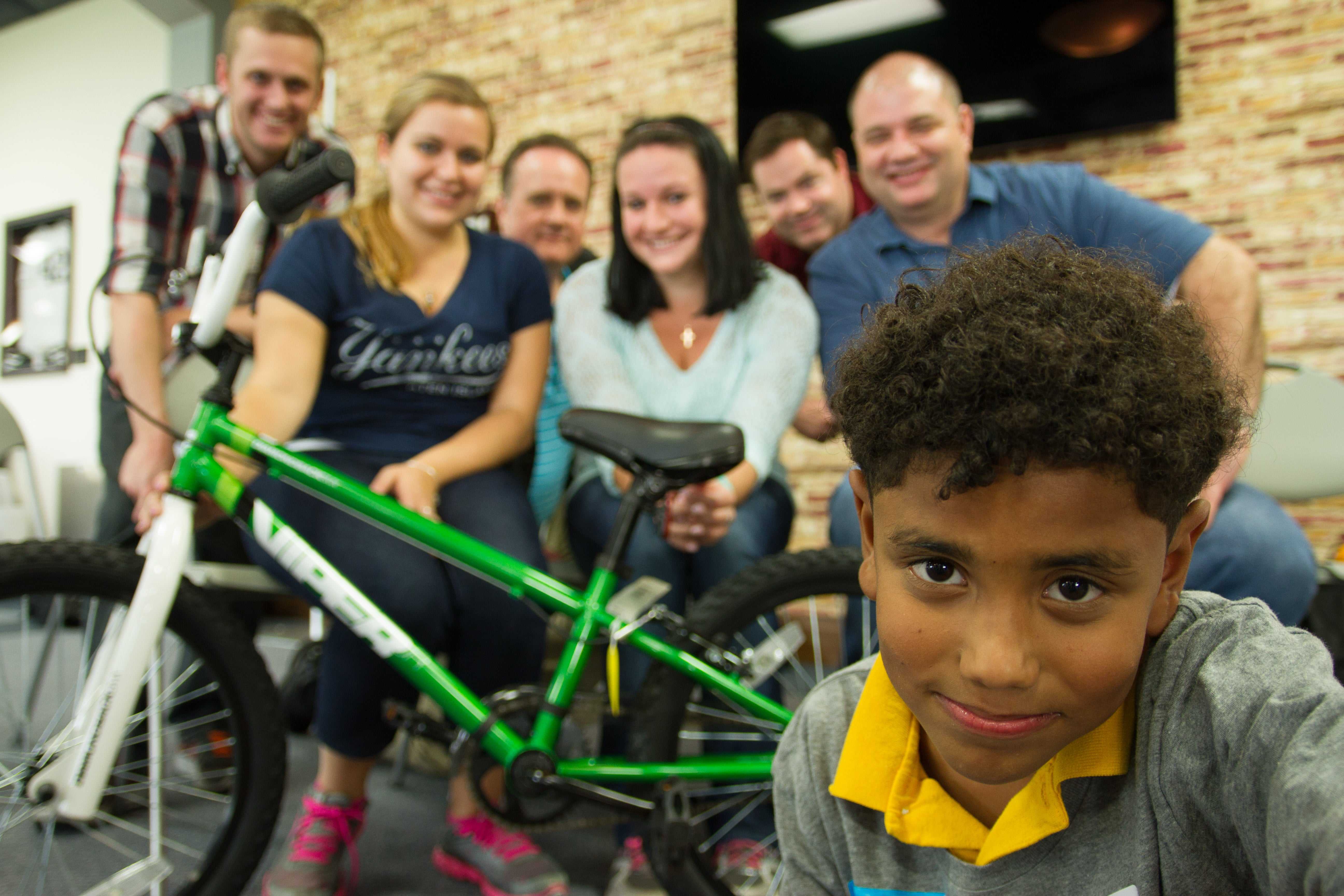 MBA students building bicycles for children as part of philanthropic team building in MBA programs