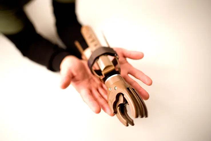 Recipient using a prosthetic hand from Build-a-Hand program