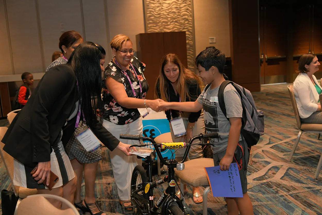 Team building event with participants assembling bicycles to inspire and transform individuals before forming teams