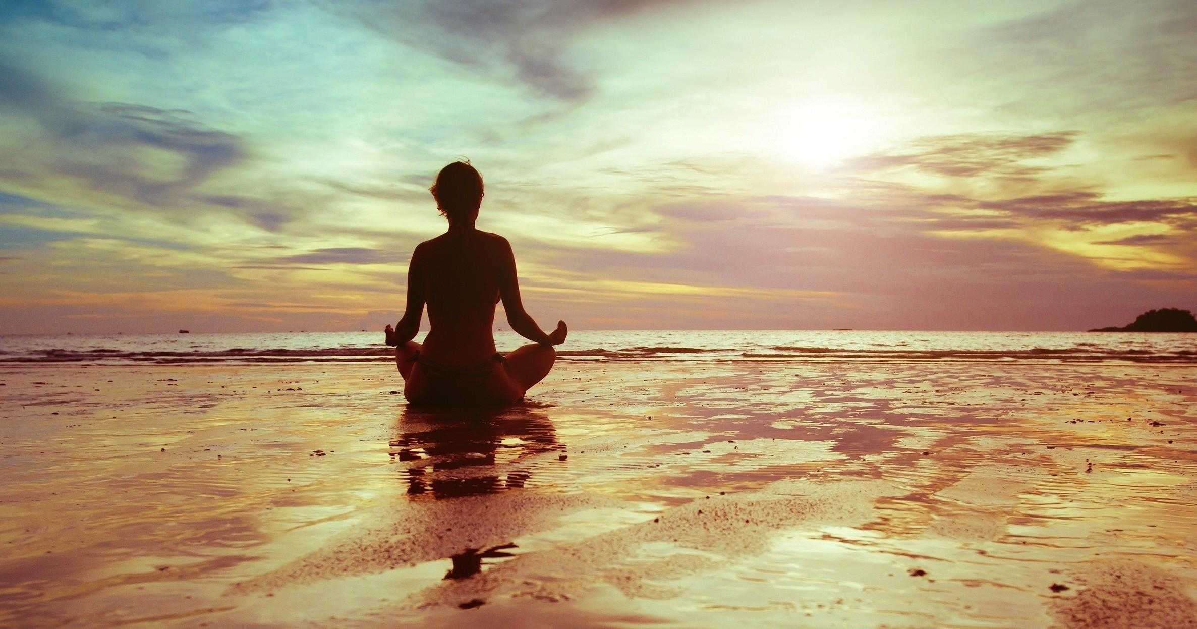Person meditating surrounded by nature symbolizing reprogram your mind and overcoming negativity