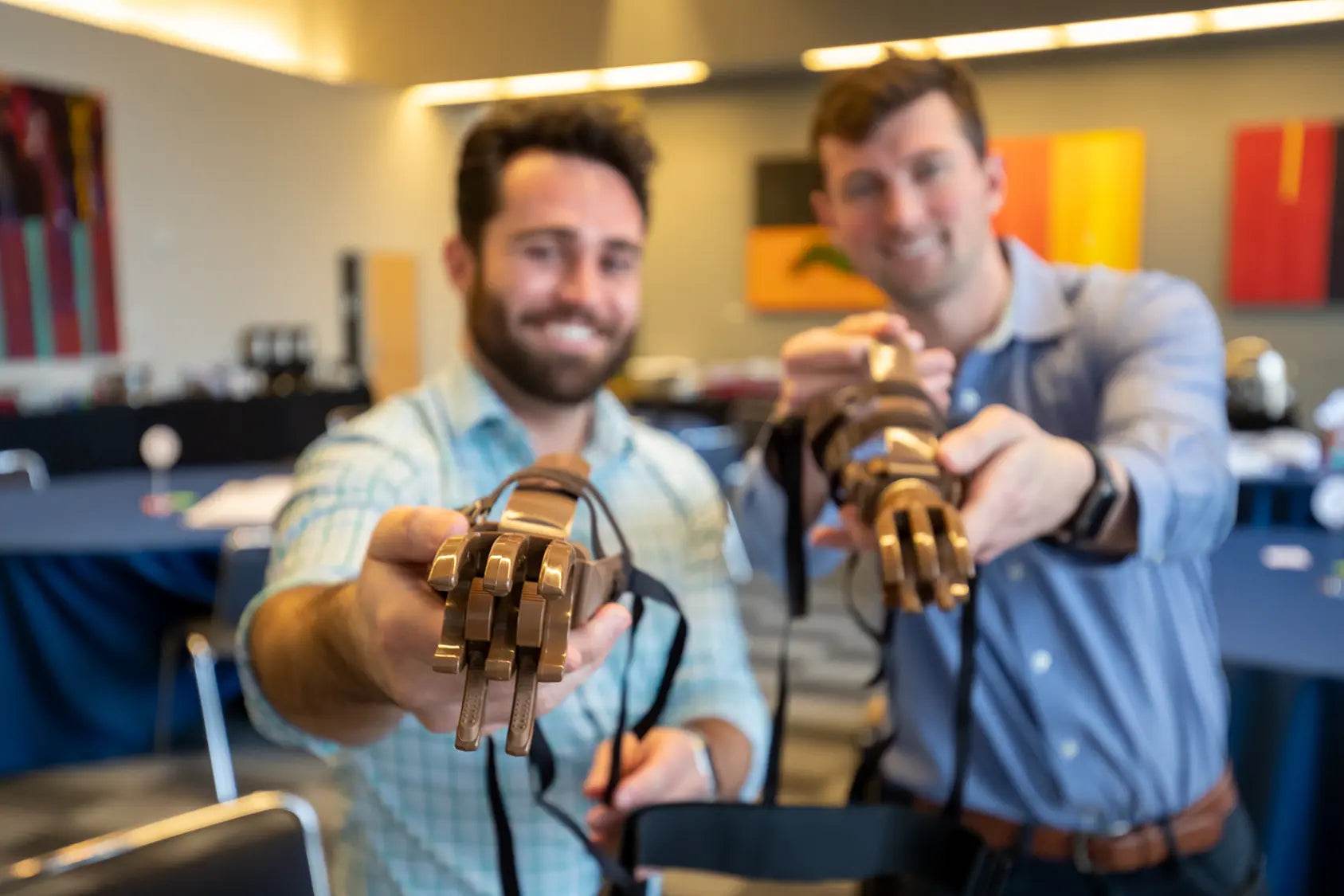 Man holding a prosthetic hand and handbag from Microsoft Build-a-Hand program for purpose-driven team building