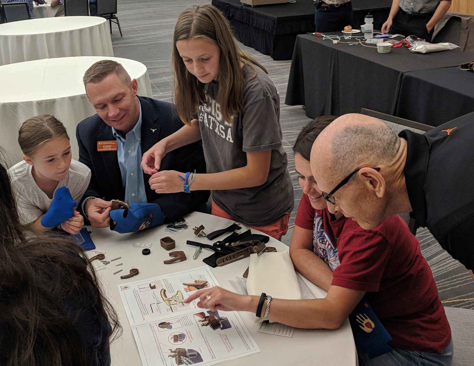 Texas McCombs MBA students building prosthetic hands in philanthropic team building program