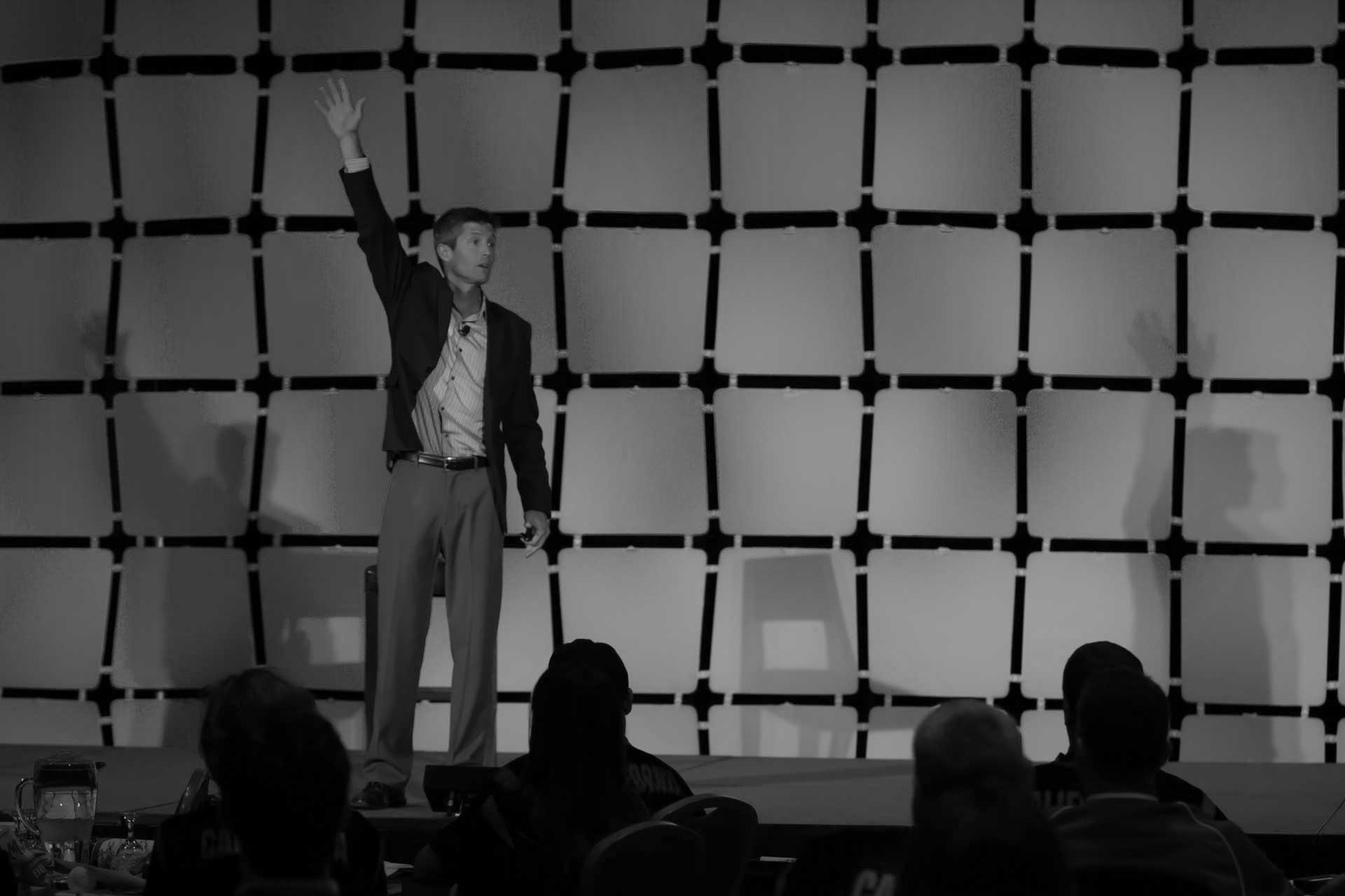 Lain Hensley presenting TEDx talk on fostering a disruptive mindset for innovation