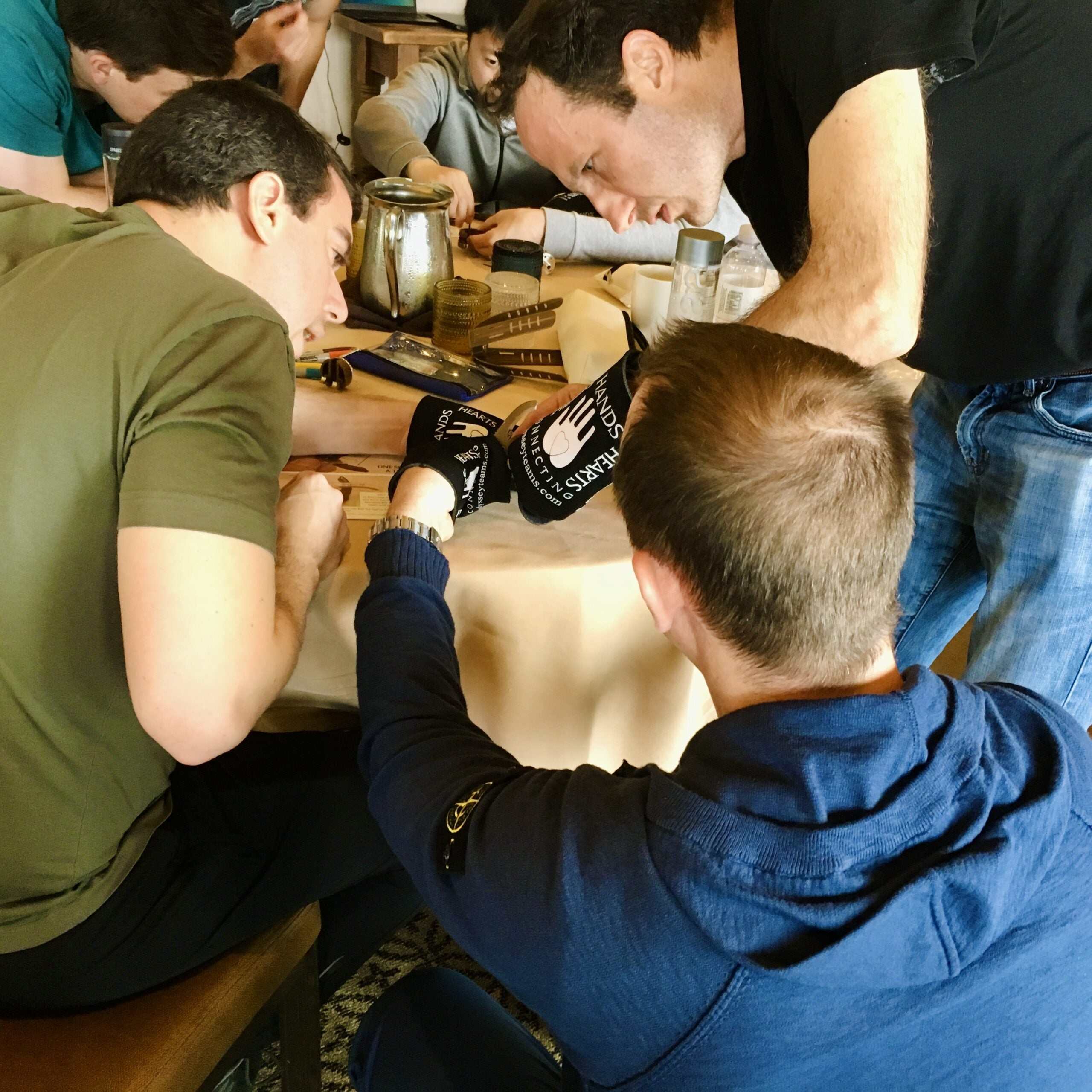 Team building activity using Build-A-Hand® Team Building Kit assembling prosthetic hand