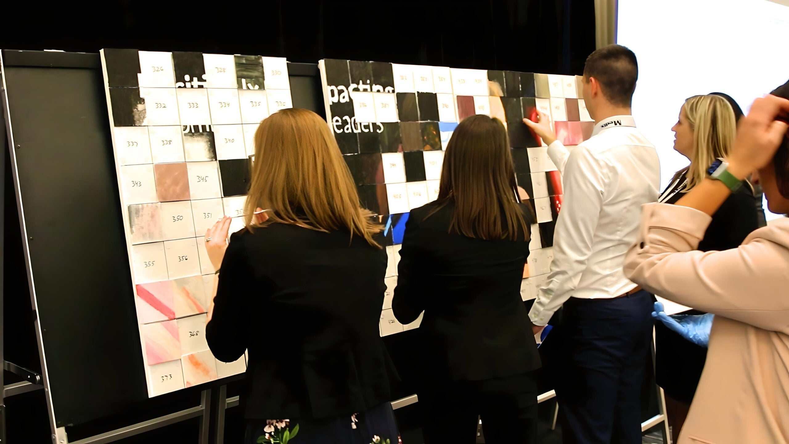 team building activity with people assembling a large mosaic artwork using Team Mosaic™ Kit pieces