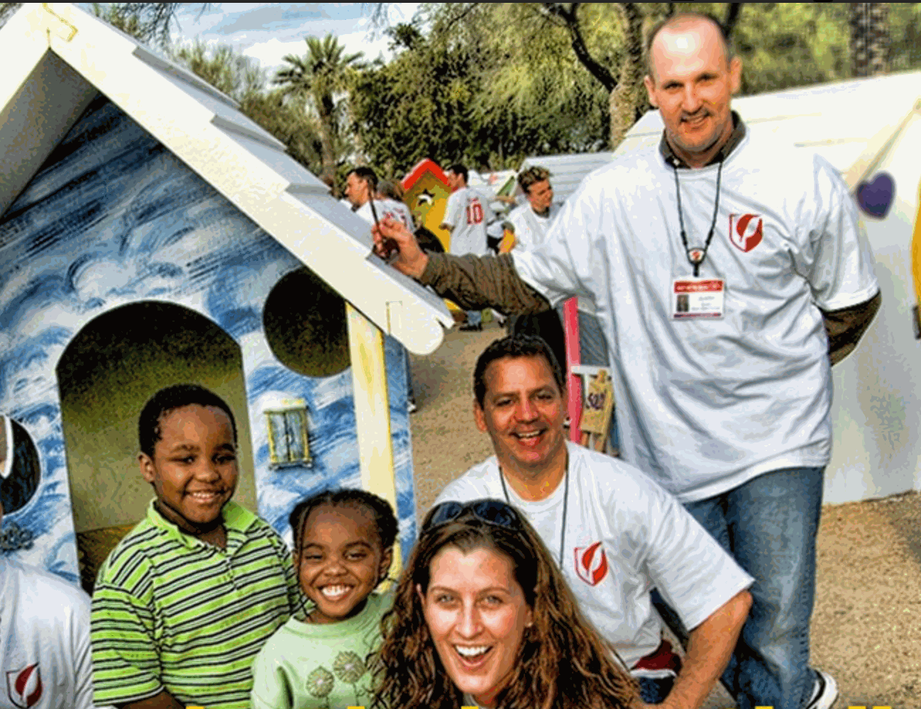 Team building with Playhouse Challenge™ Kit, group painting and assembling a colorful playhouse outdoors