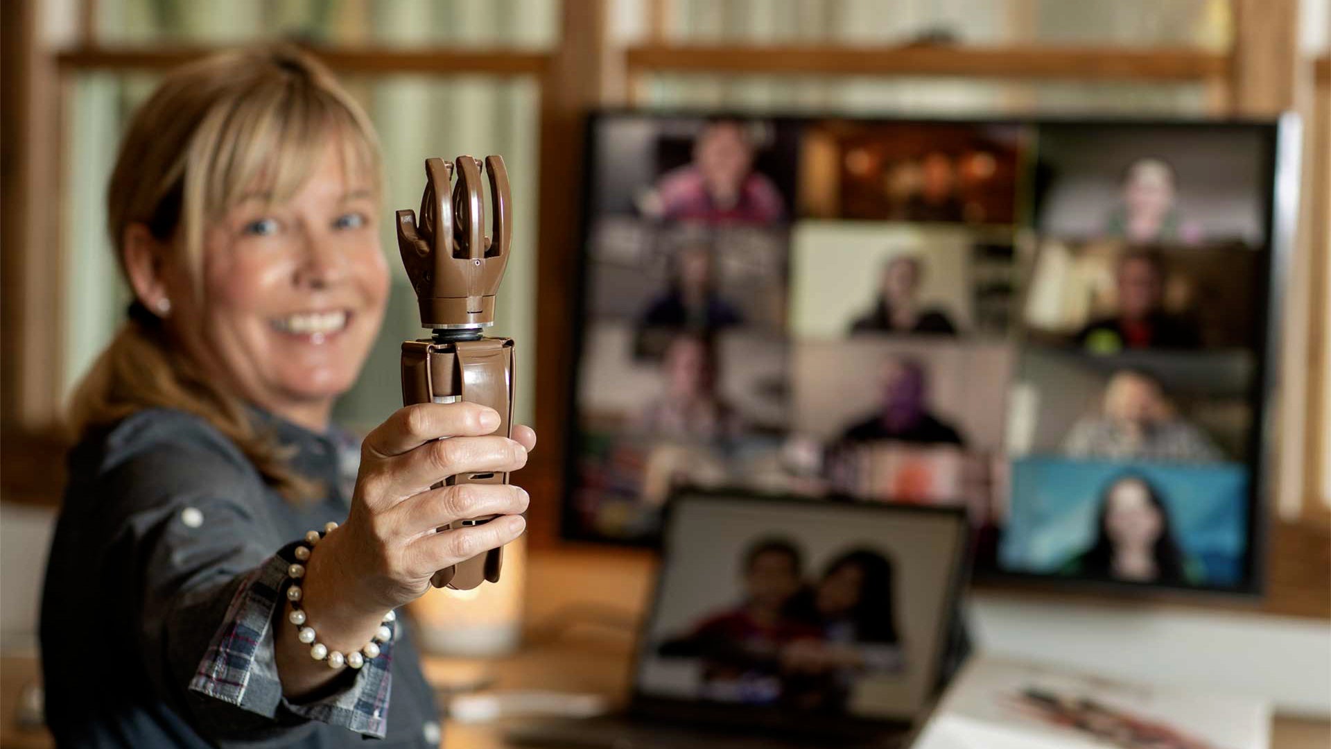 person holding a prosthetic hand after experiencing the Build-a-Hand program